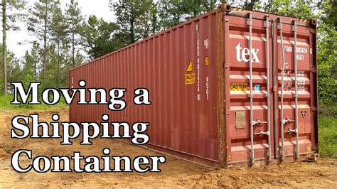 moving a shipping container with a skid steer|moving a shipping container.